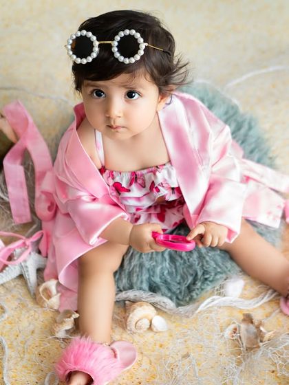 A full look at the stylish beach outfit, complete with a pink robe and fuzzy slippers. Every detail is considered in my themed photoshoots.