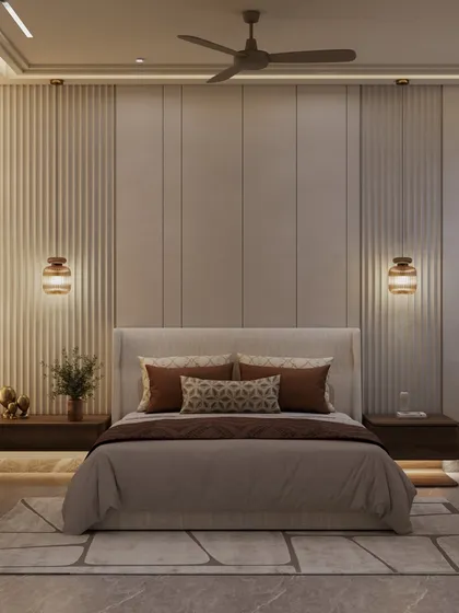 This bedroom is a peaceful retreat that feels mature, minimal, and deeply intentional. The bed is flanked by floating nightstands and warm, ambient wall sconces, set against a wall of vertical fluted panels.