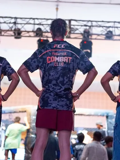 Our female fighters standing strong in their FCC jerseys, ready for battle. The camouflage design represents their strength and readiness for any challenge.