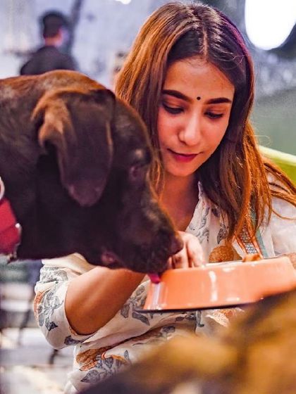 A guest shares her meal with one of our resident dogs. It's a common sight here, sharing is caring!