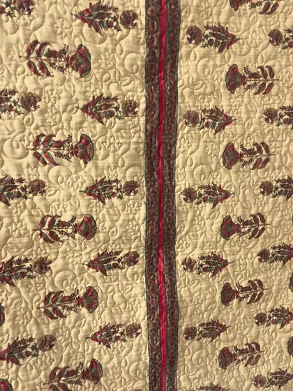 A close-up of the quilting and fabric pattern on the saree memory quilt.