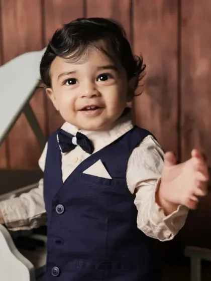 A little maestro at his piano. This classic setup with a miniature piano is timeless and elegant.