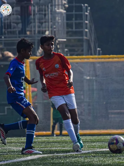 An action shot capturing the speed and agility of our young players during a competitive match.