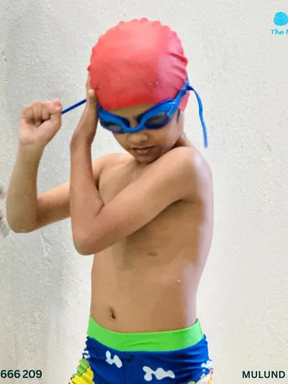 Goggles on, worries off. A young competitor gets focused and ready for his race at the Swimming Gala.