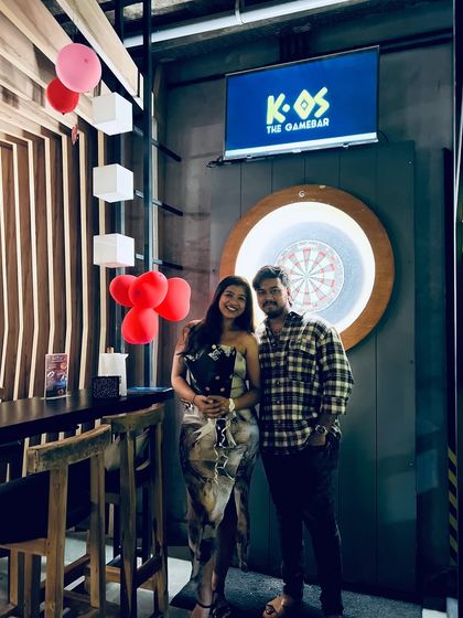 A couple celebrating their special moment with us, surrounded by heart balloons and a festive atmosphere.