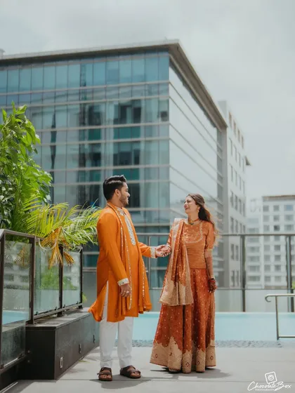 A beautiful portrait of the couple on a rooftop, with the city's modern architecture providing a stunning contrast to their traditional attire.