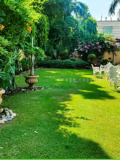 We designed this expansive garden to be a peaceful escape. It features a lush, perfectly maintained lawn complemented by classic white garden furniture, creating an elegant setting for relaxation and entertainment. Our lawn installation and maintenance services are key to achieving this look.