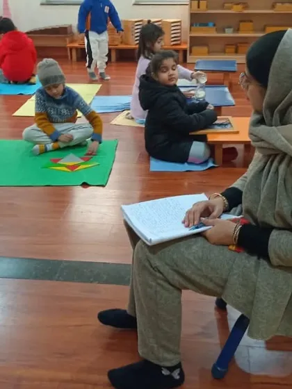 An observation session in a busy Montessori environment. Our trainees learn to see the "work" of the child in activities like pouring water or arranging geometric shapes. They see firsthand how children build themselves through these focused tasks.