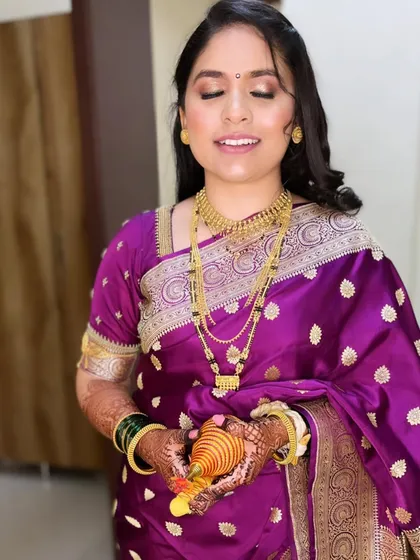 A close-up of Radhika's reception makeup. The soft gold eyeshadow and natural-looking skin create a timeless and elegant look.