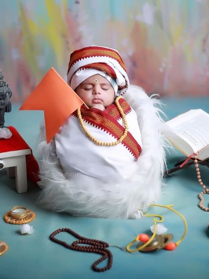 The 'Little Vitthal' setup, showing the baby sleeping peacefully amidst the carefully arranged props, including miniature idols and a holy book.