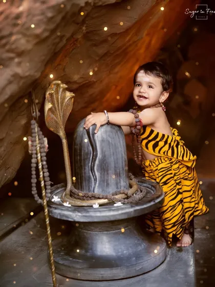 This little bhakt is full of joy as he poses next to the Shivling in our dramatic cave set.