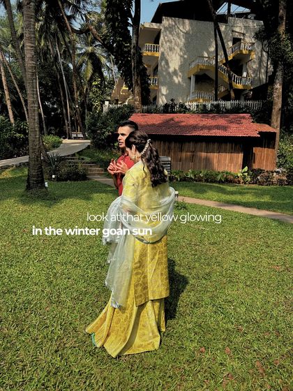 The bride's yellow outfit glowing in the winter Goan sun, a perfect choice for a daytime beach event.