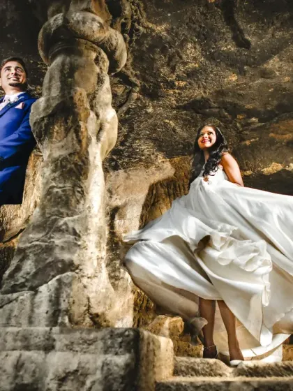 Using the natural architecture of these ancient caves to frame the couple. The play of light and shadow adds a dramatic, cinematic quality to this pre-wedding portrait.