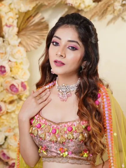 A confident portrait showcasing the unique and colorful Mehendi ensemble. The makeup is bold yet balanced, ensuring the bride shines.