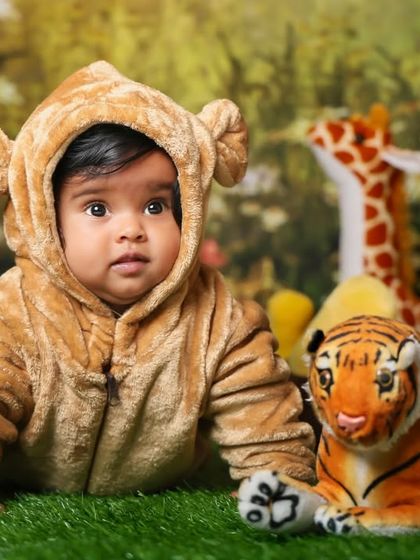 A close-up of our little jungle explorer. The costume and lush green background make for a very immersive photo.