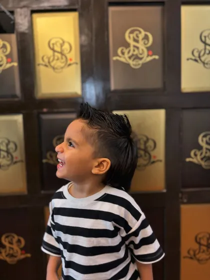 A side view of this cool kid's mohawk, showing the clean lines and expert styling.