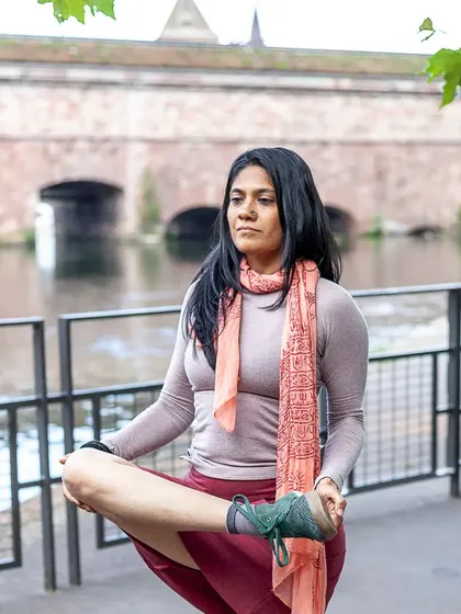 Consistency is the fruit of the tree of success. This balancing pose by the water is a reminder that with regular practice, we can find stability even in changing environments.