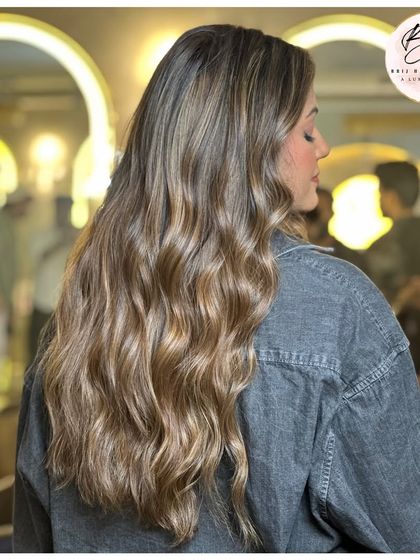 A side view of the stunning ash blonde, showing off the beautiful waves and cool tones.