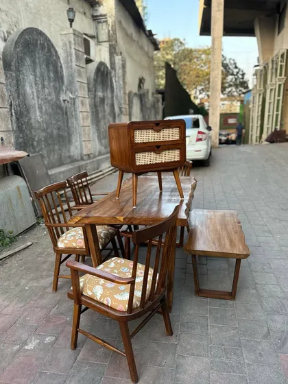 The nightstand shown as part of a larger dining set.
