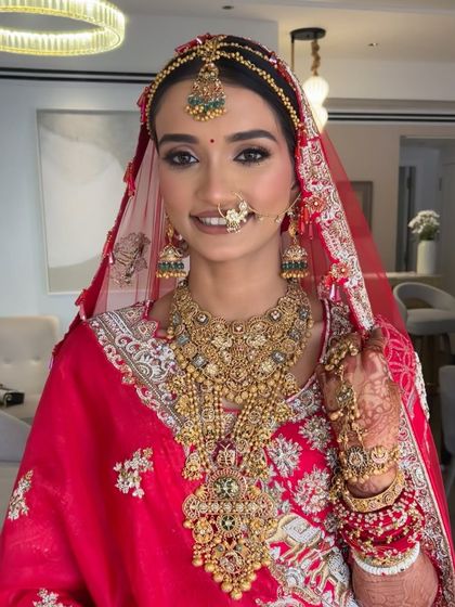 A happy bride, her smile radiating pure joy. Her classic hairstyle completes her beautiful bridal look.