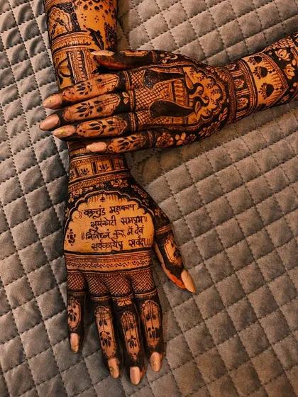 A beautiful back-hand design featuring a Sanskrit shloka for blessings. This is a wonderful way to incorporate sacred verses into your bridal mehendi.