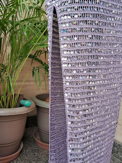 A side view of the cocktail dress, highlighting the high slit that adds a touch of modern drama and movement to the classic column-dress style.