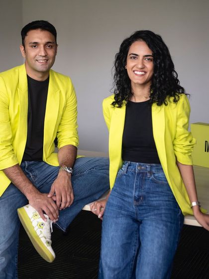 A bright and cheerful portrait of the founders of Moxie Beauty. Their coordinated yellow blazers and confident smiles perfectly reflect their brand's vibrant energy.