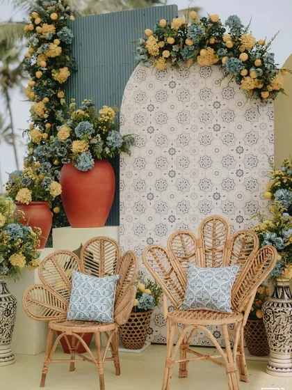Peacock-style rattan chairs set against a backdrop of modern geometric and traditional tile patterns. This was for a chic, Mediterranean-inspired Haldi by the sea.