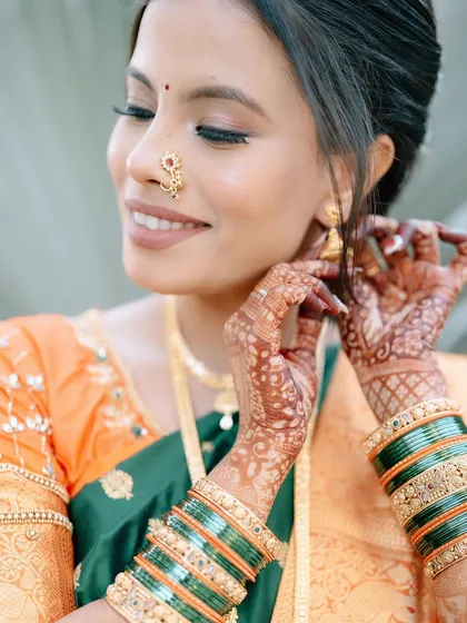 A close-up on the details, from the traditional green bangles to the delicate nose ring.