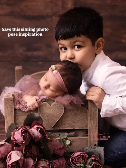 A gentle kiss for his new baby sister. This sibling pose is full of sweetness and is a perfect inspiration for your newborn family session.