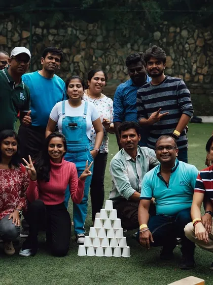 A happy team poses with their successfully built pyramid of cups. A great photo op after a fun challenge.