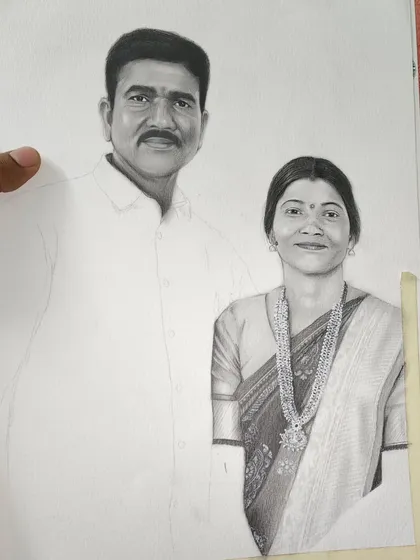 Another progress shot of the same couple's portrait. Here, the woman's saree and jewelry are fully detailed, while the man's shirt remains a blank outline.