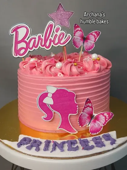 A pretty in pink Barbie cake for a little princess. The design includes the classic Barbie silhouette and beautiful butterfly accents.