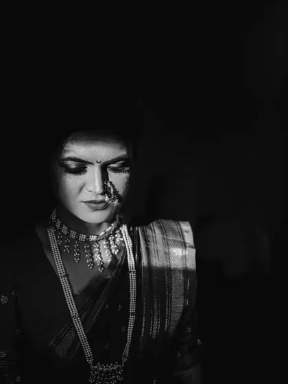 A slightly different take on the dramatic light portrait. This black and white photo of Kinjal has a quiet, introspective feel, highlighting the beautiful details of her bridal jewelry.
