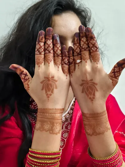 A playful pose showing off the simple and elegant Chhath Puja mehndi.