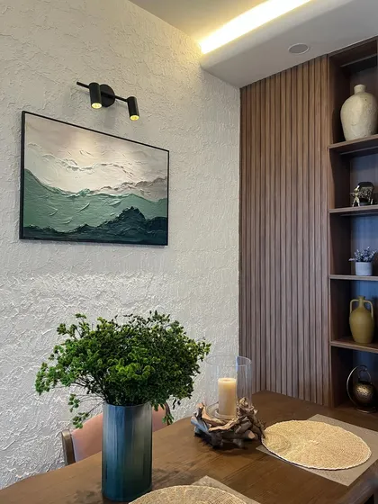 A wider view of the textured mountainscape artwork installed in the client's home. It complements the modern interior decor, adding a touch of organic texture to the wall.