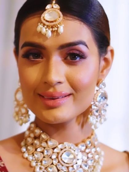 A smiling bride showcasing her pink glam makeup. The look is fresh, radiant, and full of joy, perfectly capturing the spirit of the celebration.