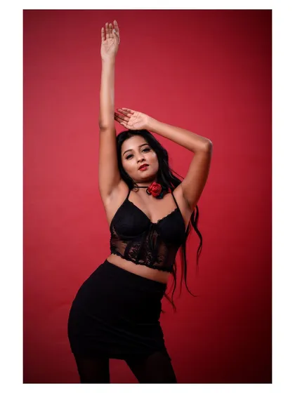 A more dynamic pose from the same shoot, with the model's arm raised, adding a sense of drama and movement.