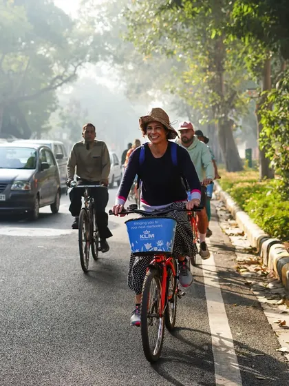 The simple joy of cycling on a sunny day in Delhi. This rider's smile captures the carefree feeling of exploring the city on two wheels.