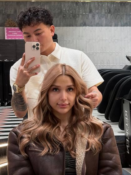 A selfie with the client, showing off her gorgeous new honey-blonde hair and my process.