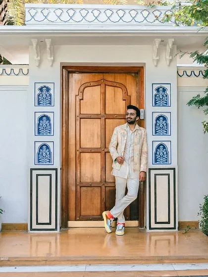 The complete look, paired with colorful sneakers, shows how to inject personality into a traditional outfit. This is modern groom style at its best.