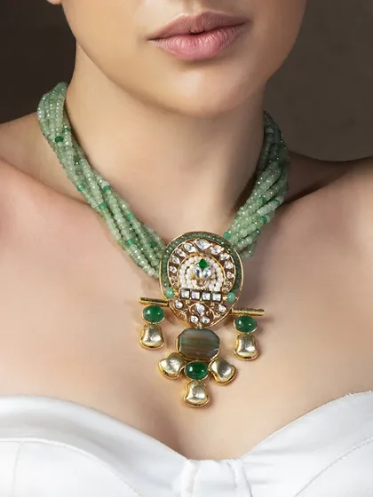 A beautiful necklace featuring a multi-strand light green bead design with a traditional polki pendant, perfect for a subtle yet elegant look.