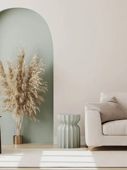 A calming and minimalist interior using a combination of off-white, sage green, and natural wood tones.