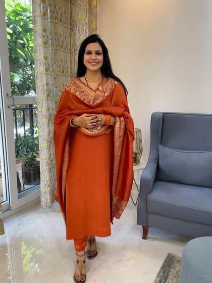 This orange suit was designed from scratch for a festive occasion. The simple silhouette allows the vibrant color and the beautiful Banarasi dupatta to be the heroes of the outfit.