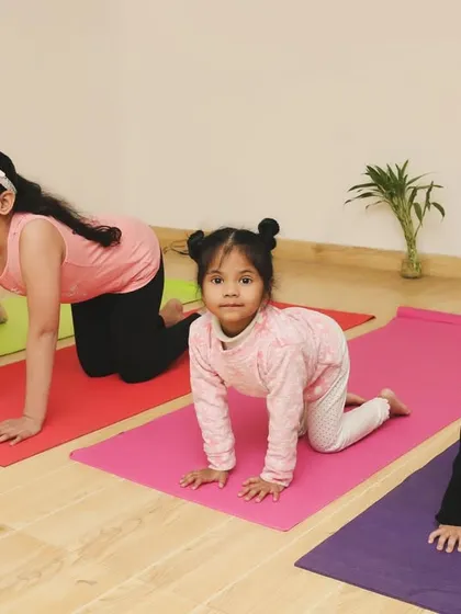 Here we are practicing our Marjaryasana-Bitilasana, or Cat-Cow poses. This gentle flow is great for spinal flexibility. We often pretend we are different animals, which brings so much laughter to our kids yoga class.
