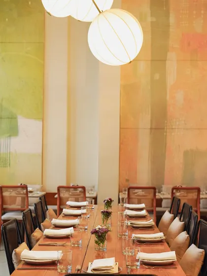 A beautifully set long table at our Malcha Marg cafe, ready for a private dinner. The warm lighting and elegant decor create a special atmosphere for any event.