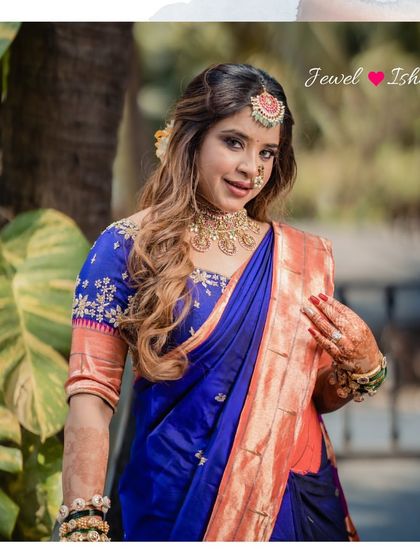 A portrait of a real bride on her engagement day, wearing a beautiful gold-plated Temple Jewellery choker with her royal blue saree.