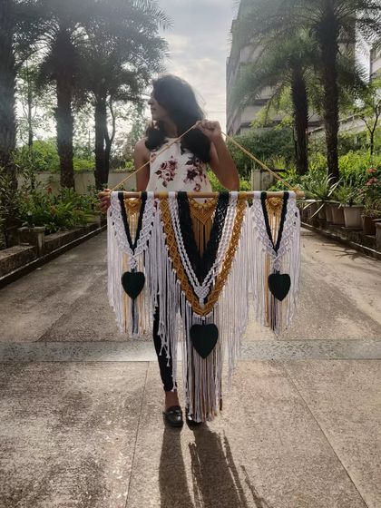 A silhouette shot with one of our beautiful three-panel macrame wall hangings. The combination of mustard, green, and white is one of our favorite palettes.