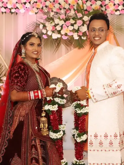 The varmala exchange, a beautiful ritual. The bride's makeup is sweat-proof and designed to last through the long wedding day.