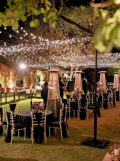 A welcome dinner under the stars. We used strings of fairy lights to create a magical canopy over the outdoor dining area, setting a warm and inviting tone for the wedding festivities.